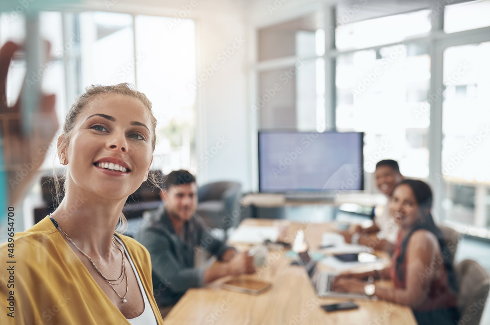 Getting her team to understand her vision. Shot of a young businesswoman using a glass wall during a