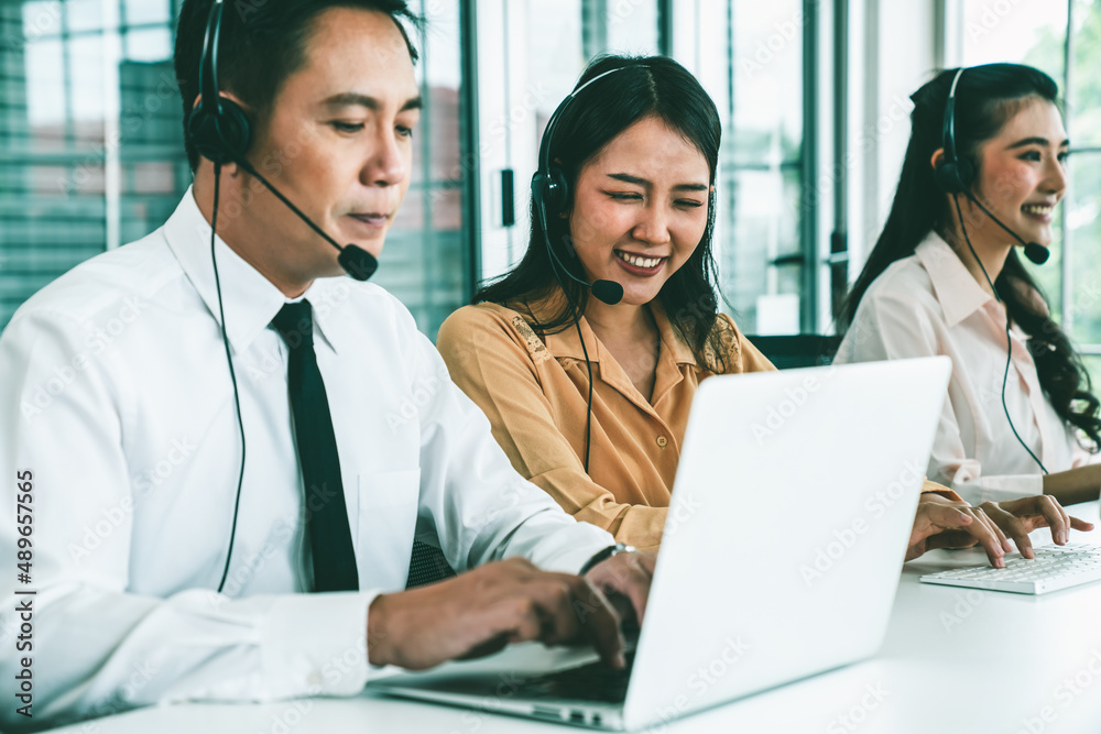 Business people wearing headset working actively in office . Call center, telemarketing, customer su