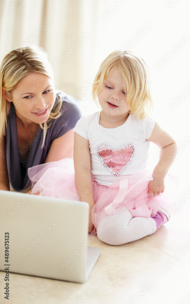 Shes a quick little learner. Shot of a mother and daughter bonding while surfing the internet togeth