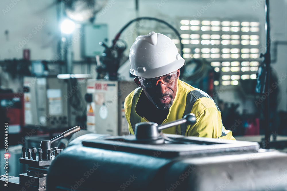 Factory worker or engineer do machine job in adept manufacturing workshop . Industrial people and ma