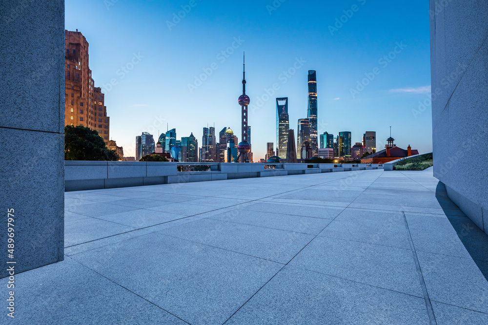 Empty square floor and city skyline with buildings in Shanghai at night, China.