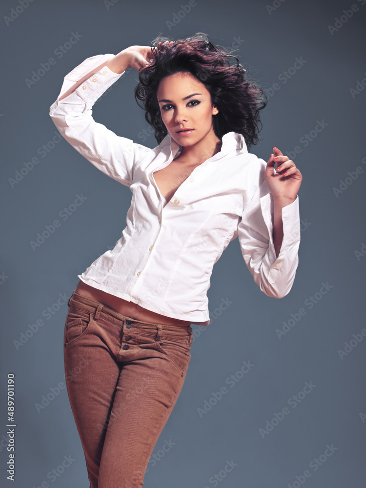 Modeling your clothes with confidence. Studio portrait of a fashionable young woman posing against a