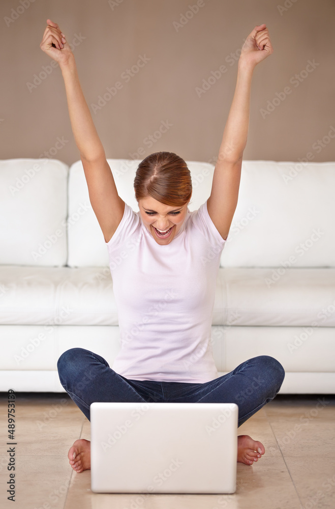 Done. Full length shot of an attractive young woman feeling cheerful and celebrating while using her