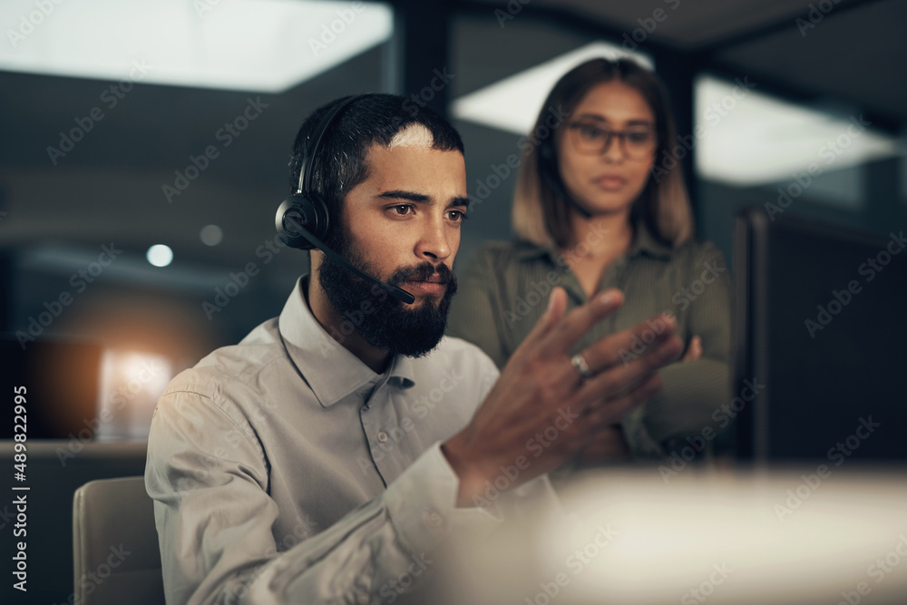 I could use your help to figure this one out. Shot of a call centre agent working in an office along