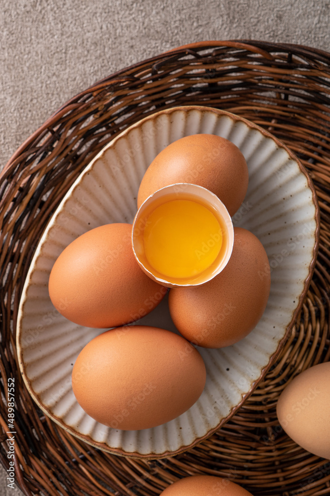 Fresh brown chicken eggs in a plate.