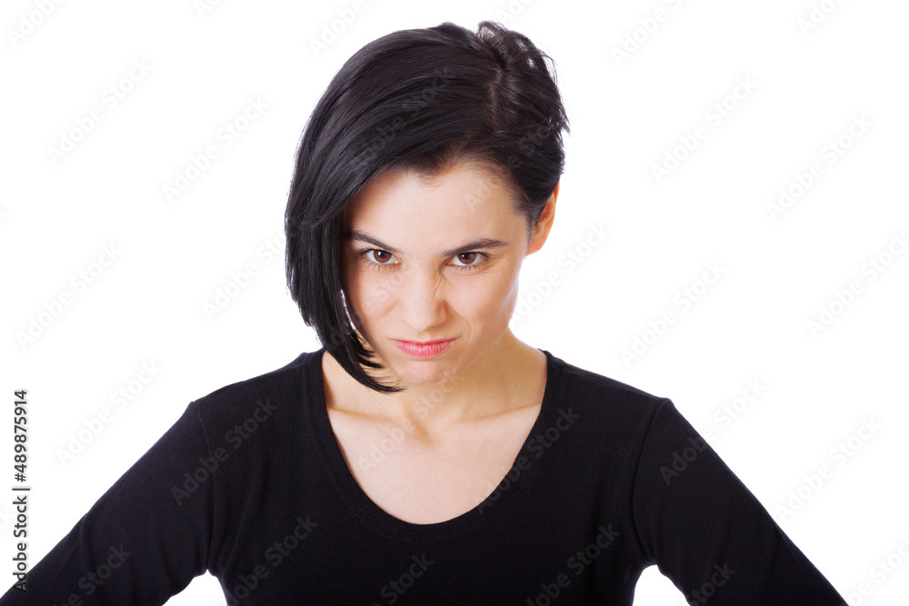 Shes got fire in her belly. Portrait of an attractive young woman showing aggression against a white