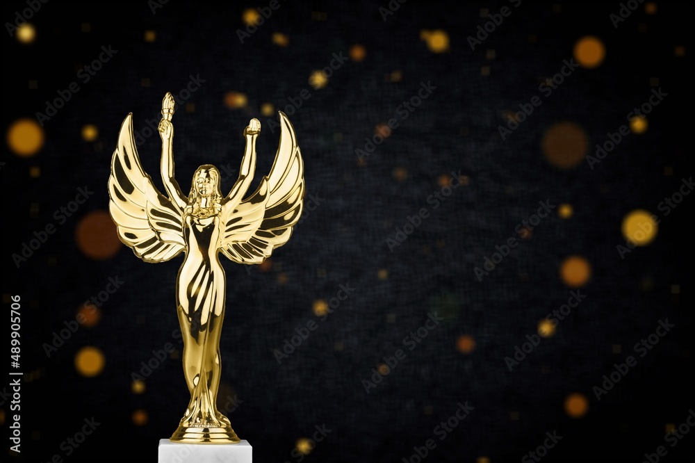 Golden metal trophy cup. Festive light background.