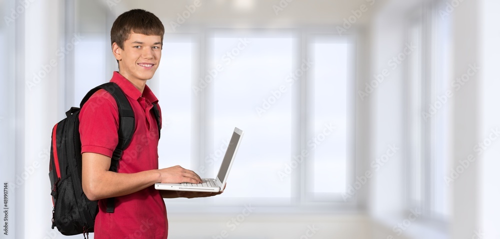 Happy young student at the university background