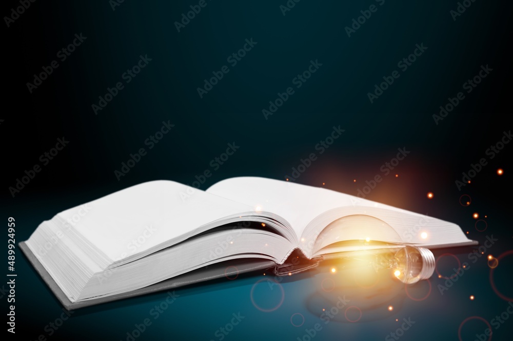 Bright lamp or glowing light bulb with book. Business success idea or solution concept. Thinking