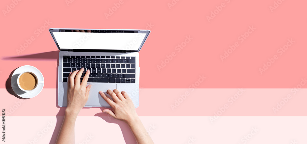 Person using a laptop computer from above