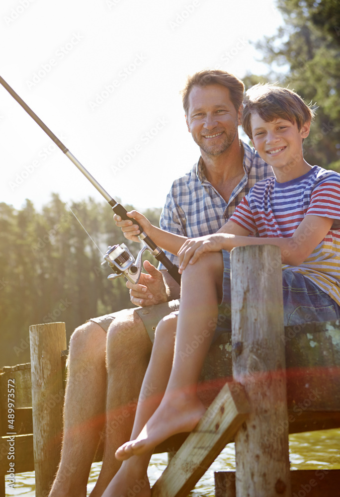 Learning from the professional. Cropped shot of a father and son fishing.