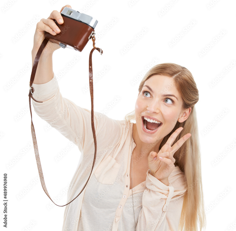 Selfies are the best. A beautiful young photographer standing with her camera against a white backgr