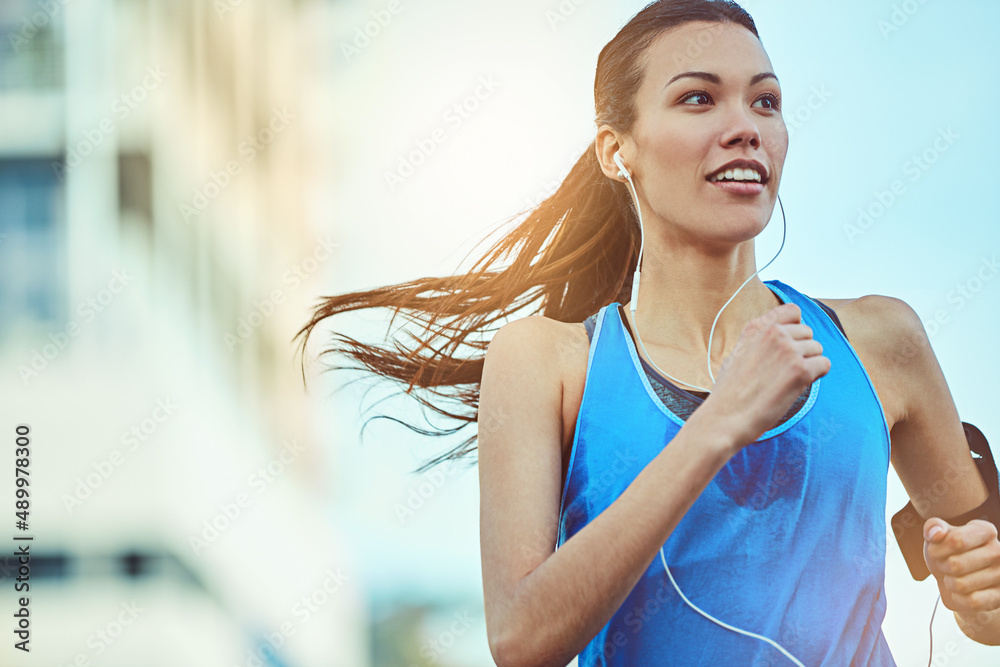 Be in shape, stay in shape. Shot of a young woman out in the city for her morning run.