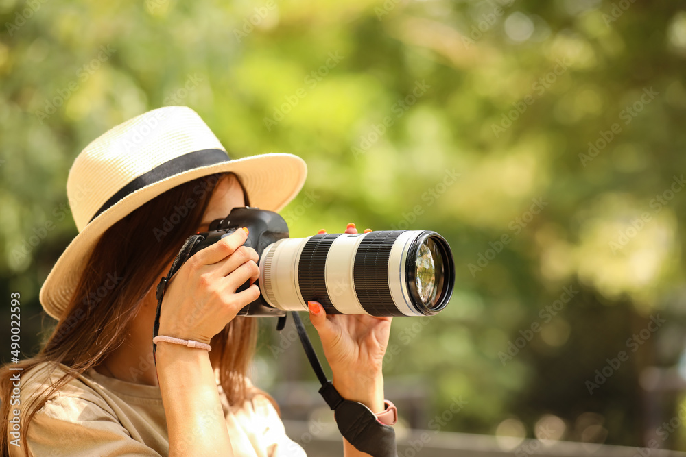 Young female photographer in park