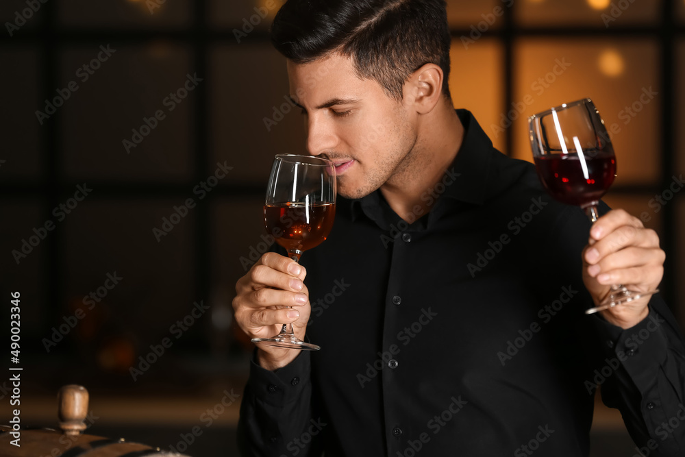 Young male sommelier tasting types of wine