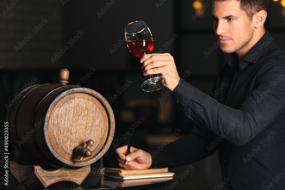 Young male sommelier tasting types of wine