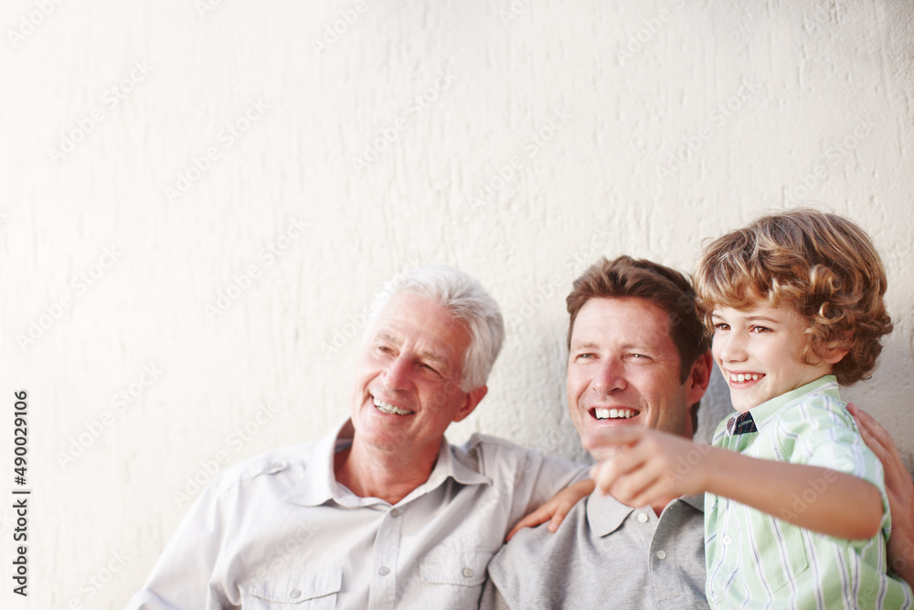 Look at that. Cropped shot of a handsome man sitting with his father and his son.