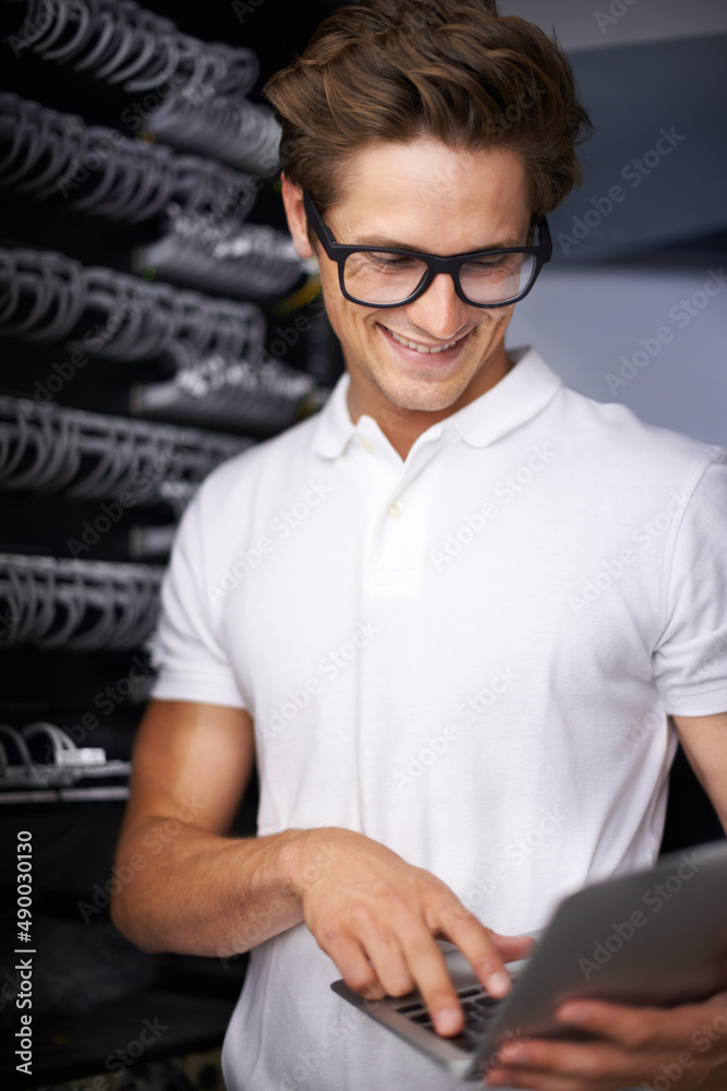 Taking care of your network needs. A young technician working on a server.