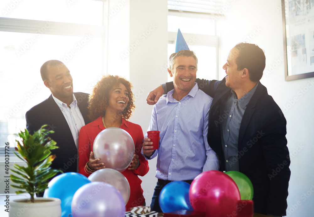 Celebrating office birthdays. Shot of a coworkers having a office birthday party.