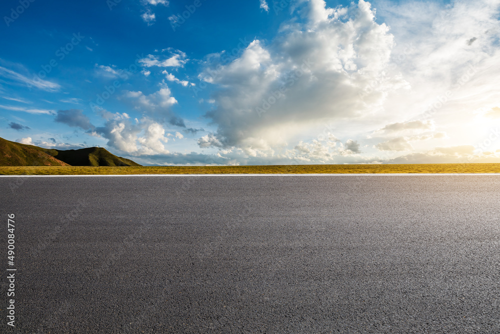 Empty asphalt road platform and beautiful blue sky with white clouds at sunrise