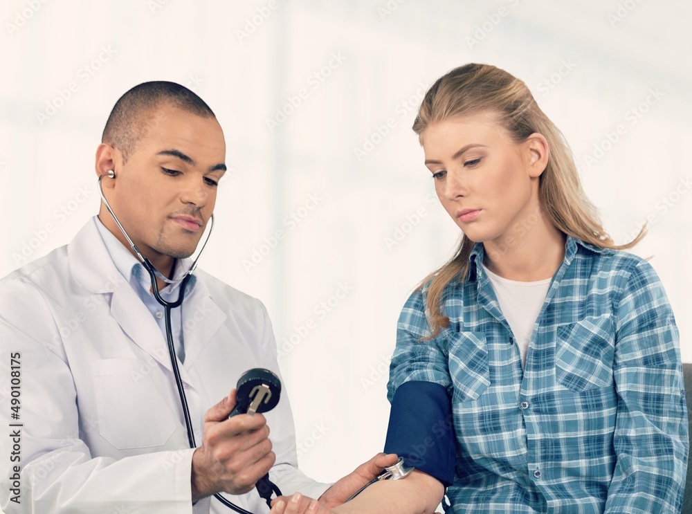 Doctor discussing treatment with cheerful smiley patient. Happy physician