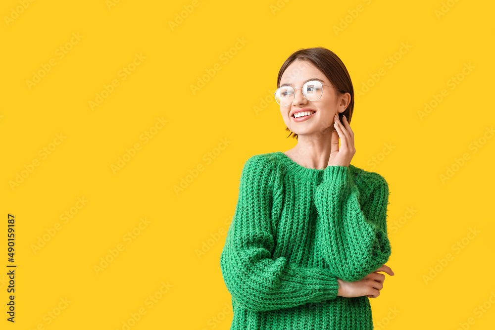 Portrait of pretty woman wearing glasses on color background