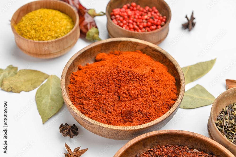 Bowls with aromatic spices on white background