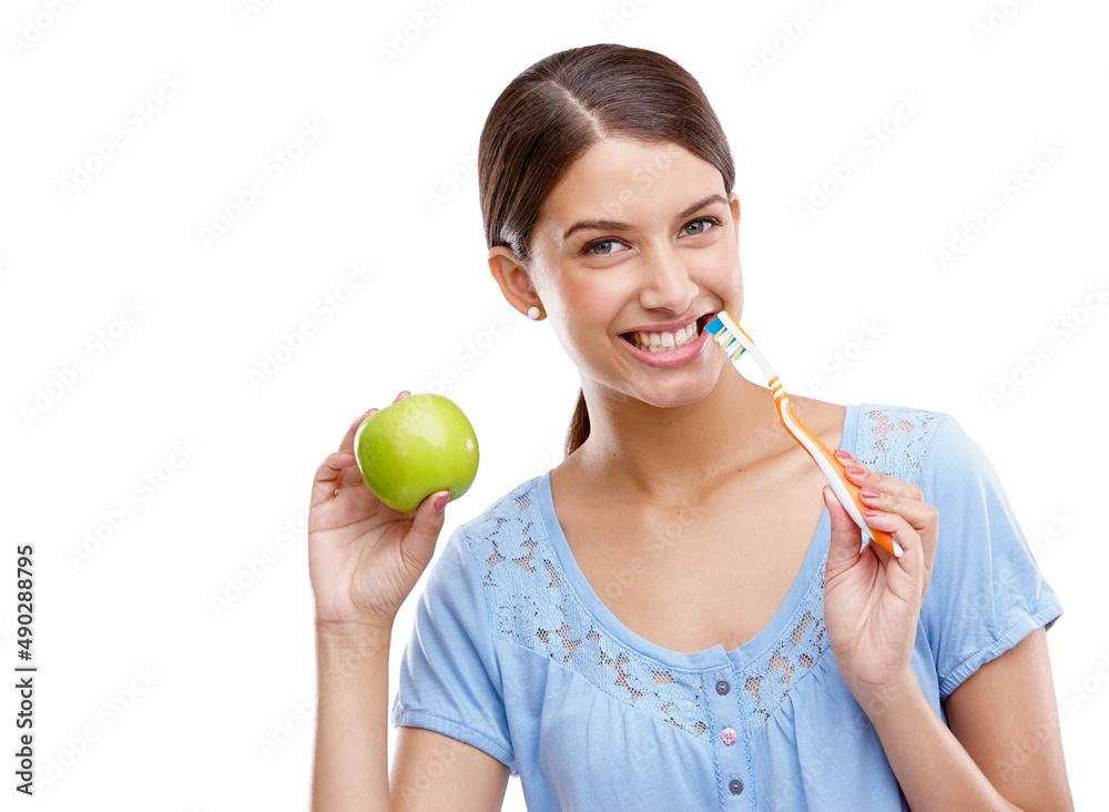 An apple a day... you know the rest. Studio portrait of a beautiful young woman holding her toothbru