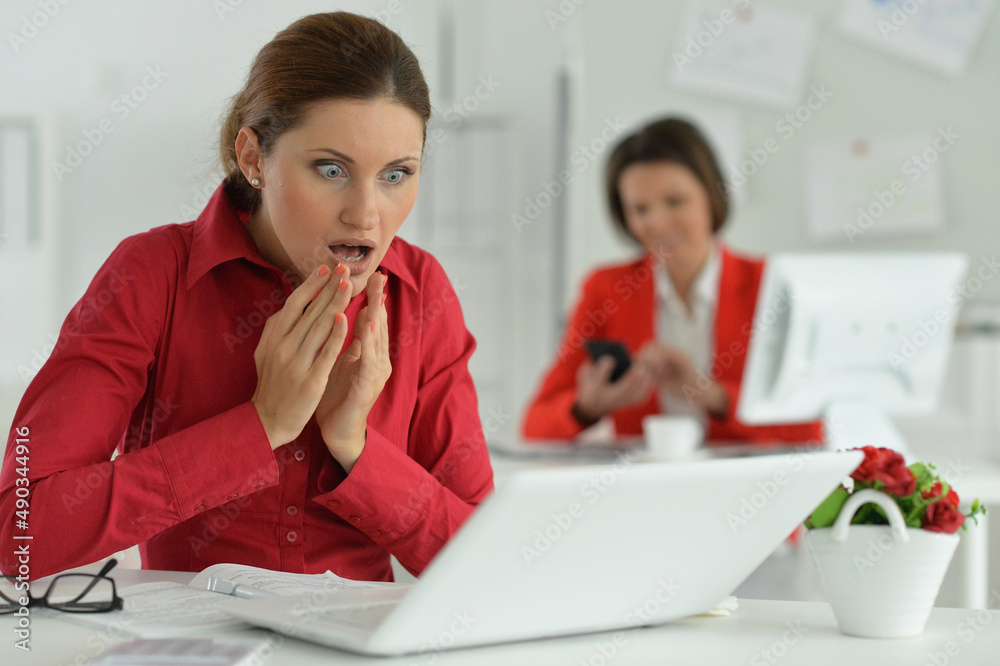 Confused businesswoman architect working in modern office with her colleague