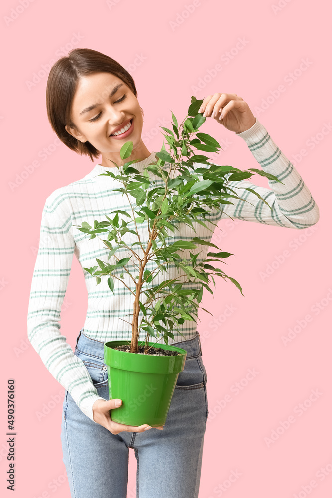 Beautiful young woman with houseplant on color background