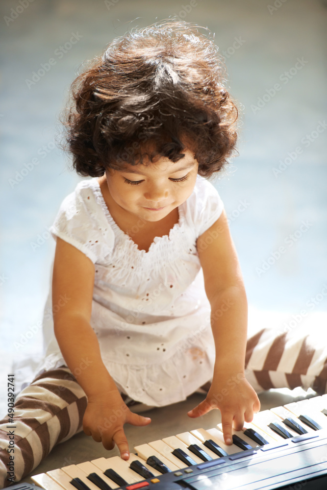 Learning as she grows. Shot of a cute little girl at home.