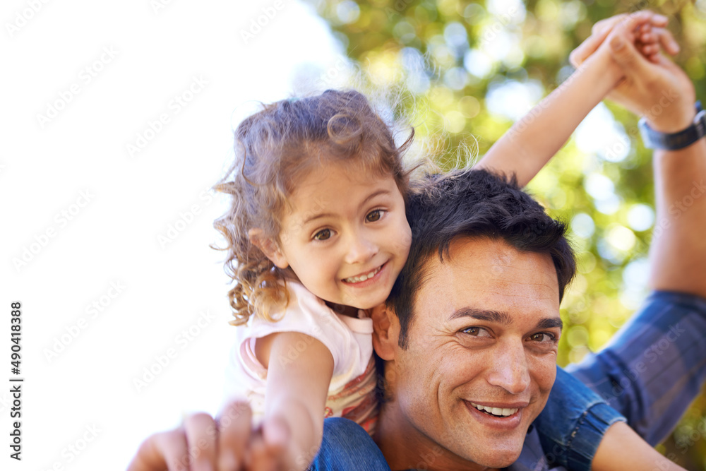 Shes my little airplane. Shot of a father giving his little girl a piggy back outside.