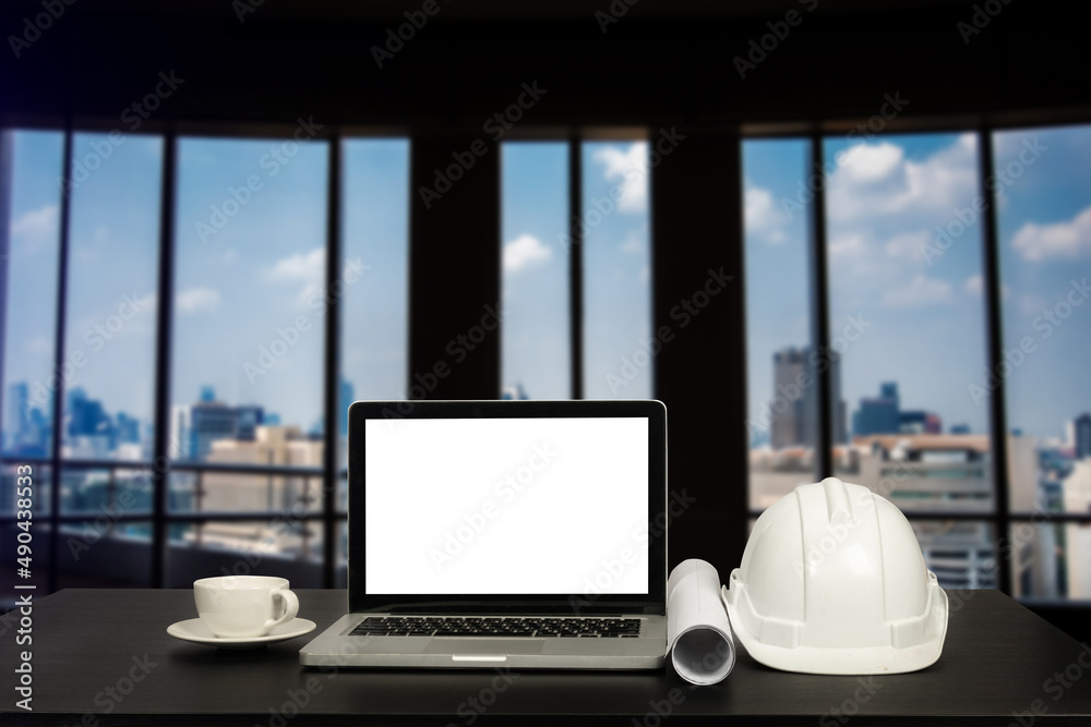  Laptop computer and office construction on table in office blurred background.Architect concept..