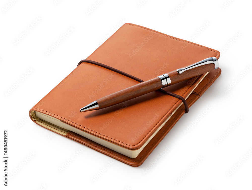 A leather notebook and pen set against a white background.