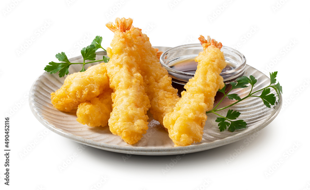 Shrimp tempura on a plate placed on a white background.