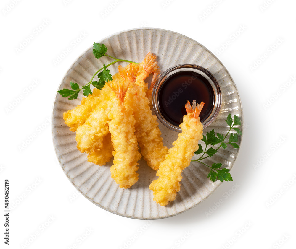 Shrimp tempura on a plate placed on a white background.