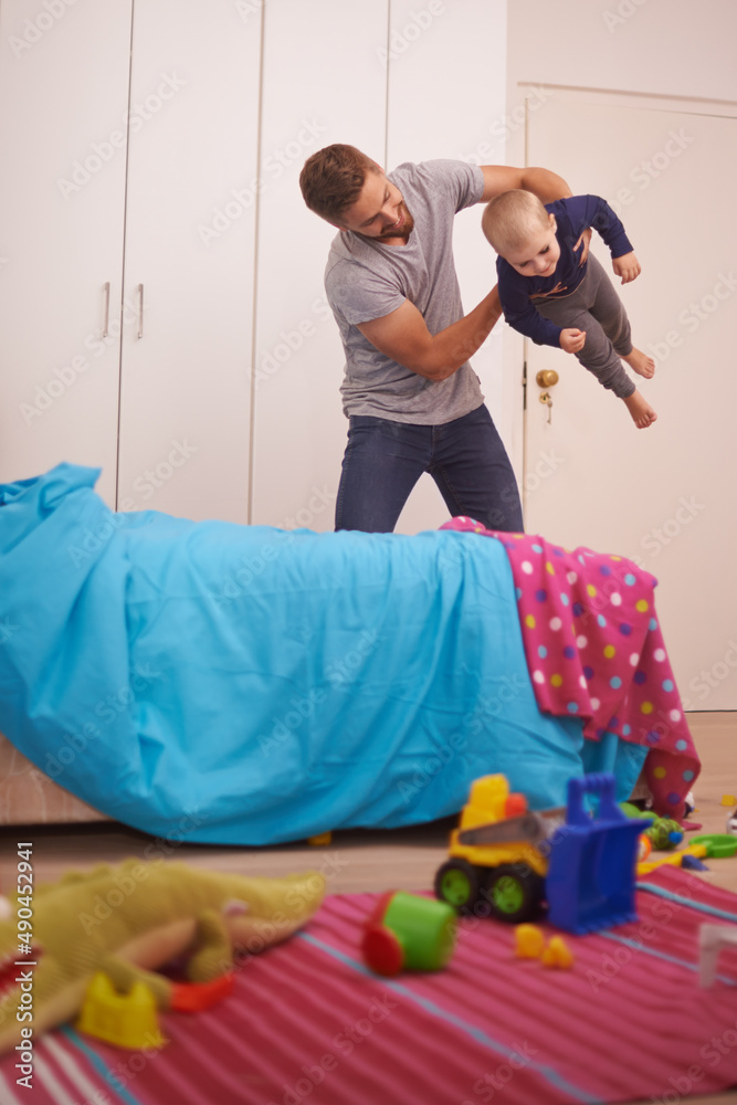 Dads the best. A young father playing with his young son at home.