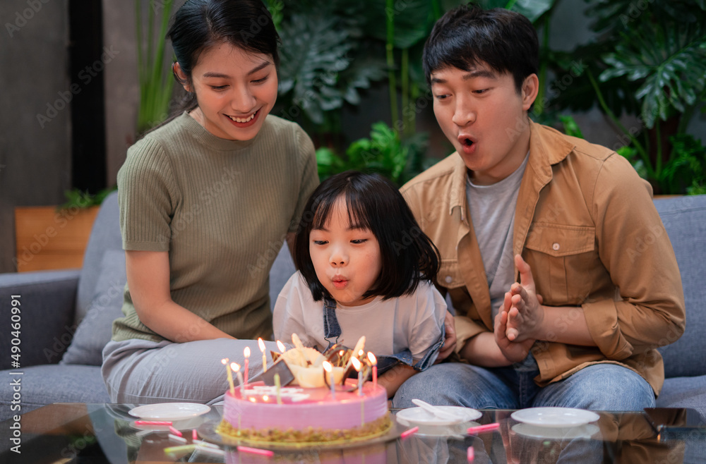 Young Asian couple celebrates their daughters birthday