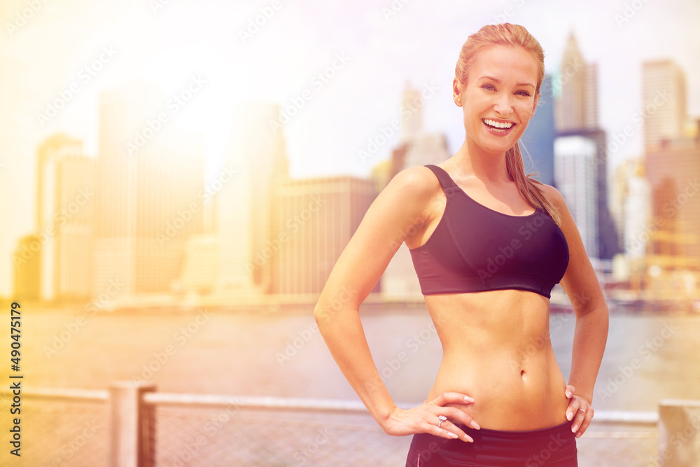 Shes full of energy. Portrait of a beautiful young woman standing beside a river while out for a run