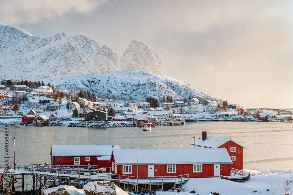 View of nordic fishing village on coastline with snow covered mountain on winter at Reine town, Lofo