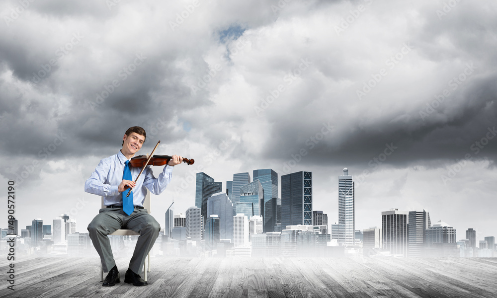 young businessman playing violin