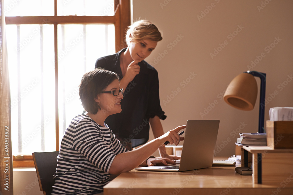 Growing their business one day at a time. A cropped shot of two focused women working together in a 