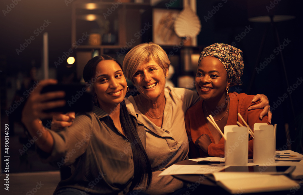 Were chasing after success as a team. Shot of a group of businesswomen taking selfies together in an