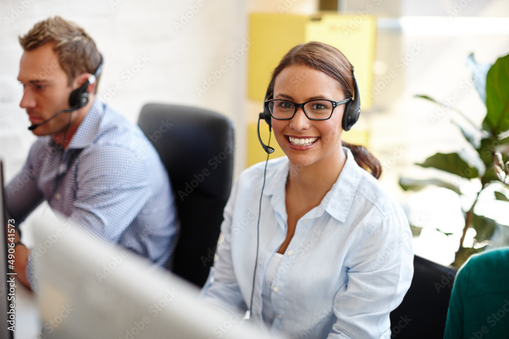 Shes got all the qualities of a great salesperson. Shot of customer service representatives taking c