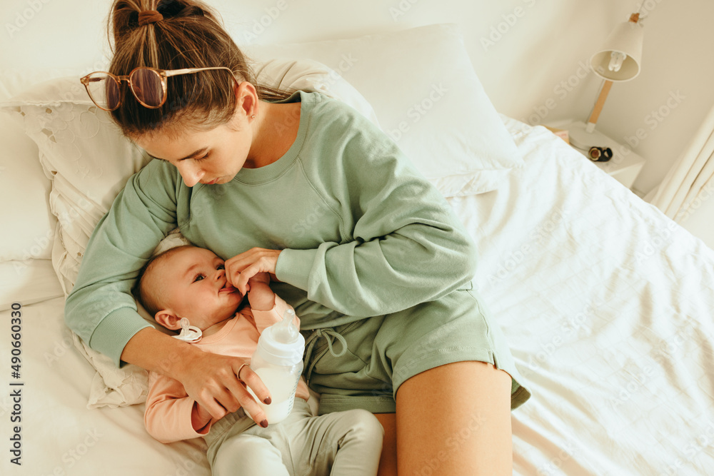 Mother feeding her newborn baby at home