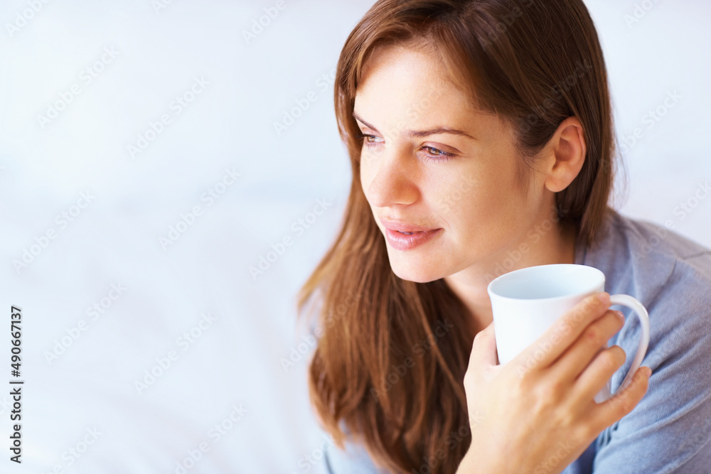 Young Caucasian female having a thought over coffee. Portrait of a cute young woman lost in deep tho