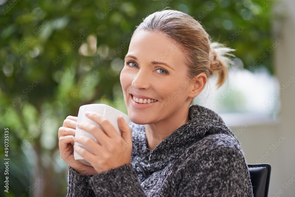 Happiness is only a sip away. Shot of an attractive mature woman enjoying a hot drink at a spa.