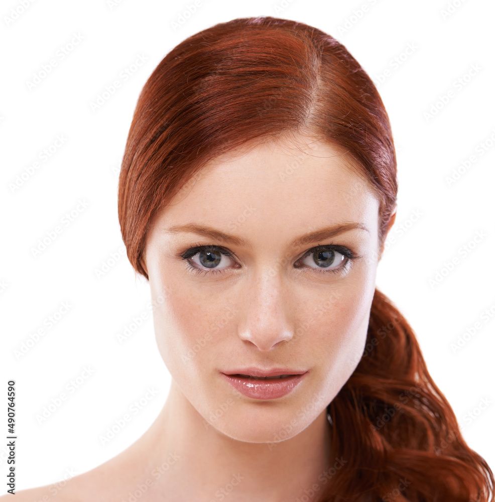 Theres a touch of elegance about her beauty. Studio shot of a redheaded woman isolated on white.