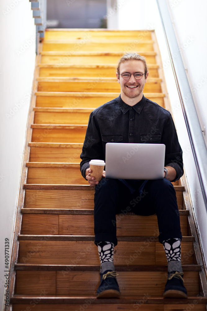 One is always busy when building a brand. Full length portrait of a handsome young businessman sitti