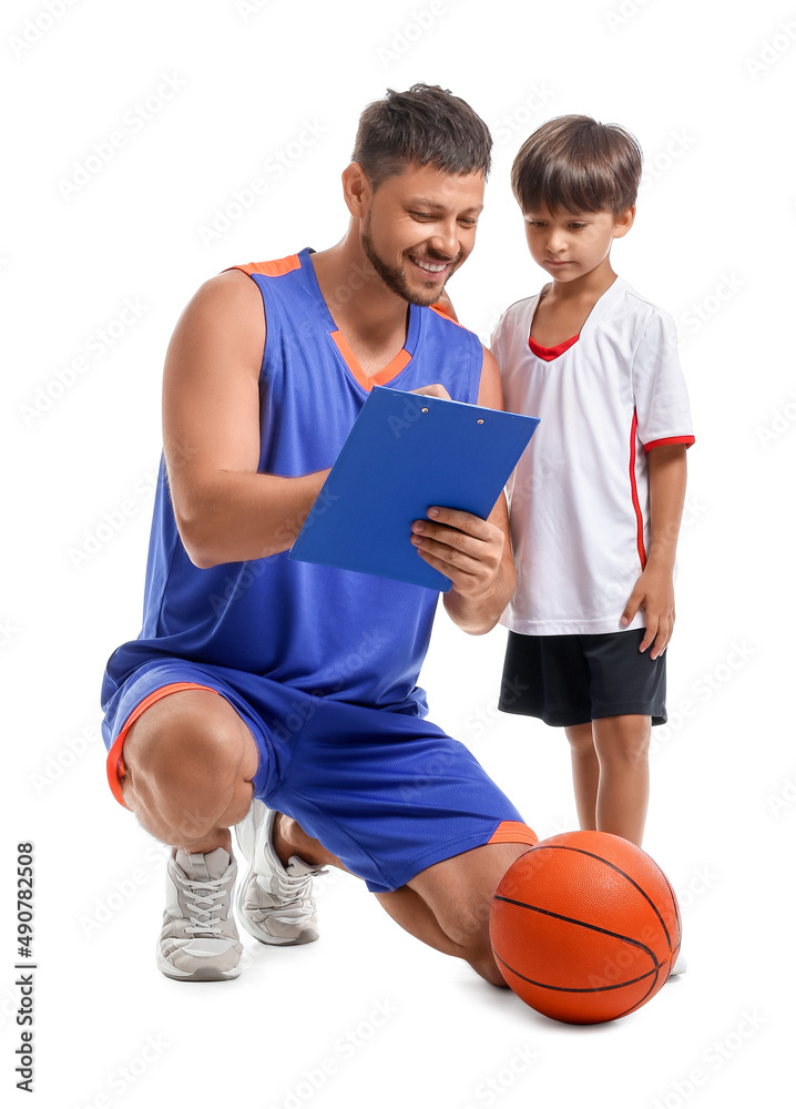 Basketball player writing in clipboard and his little trainee on white background